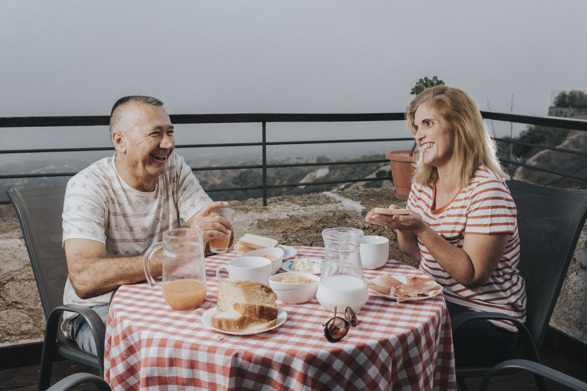 Mensen die ontbijten op een terras met uitzicht op de berg Teide, Tenerife.