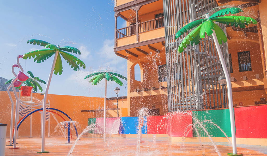 Waterspeelruimte met kunstpalmen en waterstralen op Tenerife.
