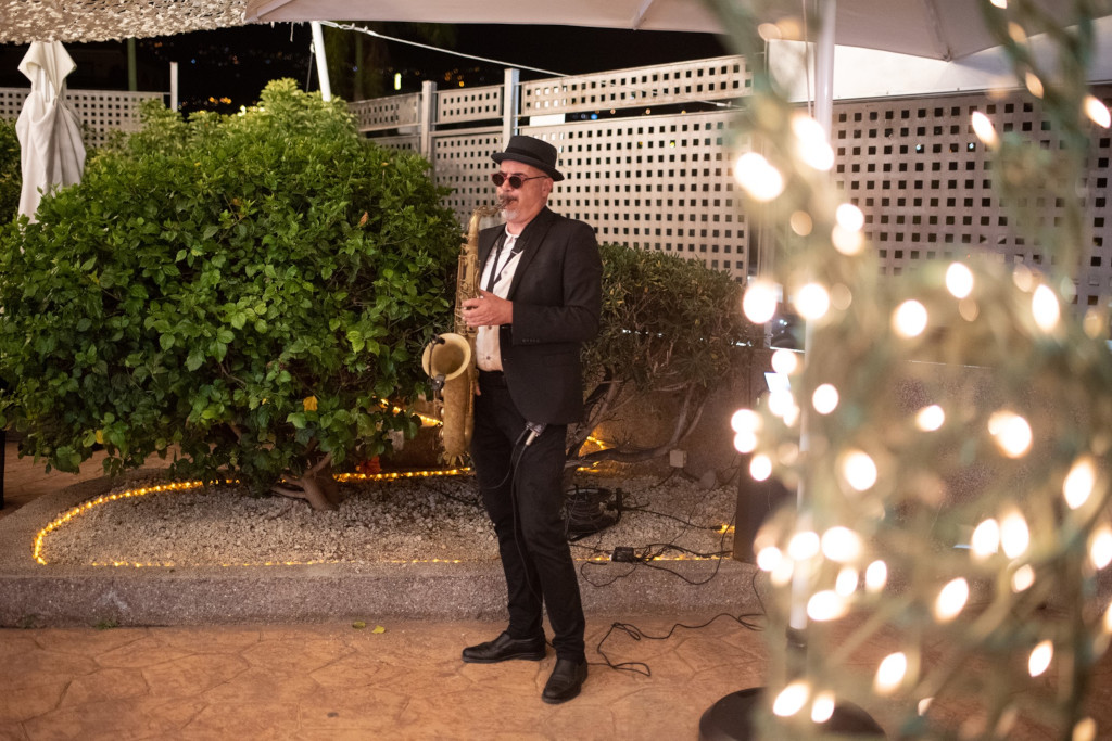 Muzikant die saxofoon speelt in een verlichte tuin op Tenerife.