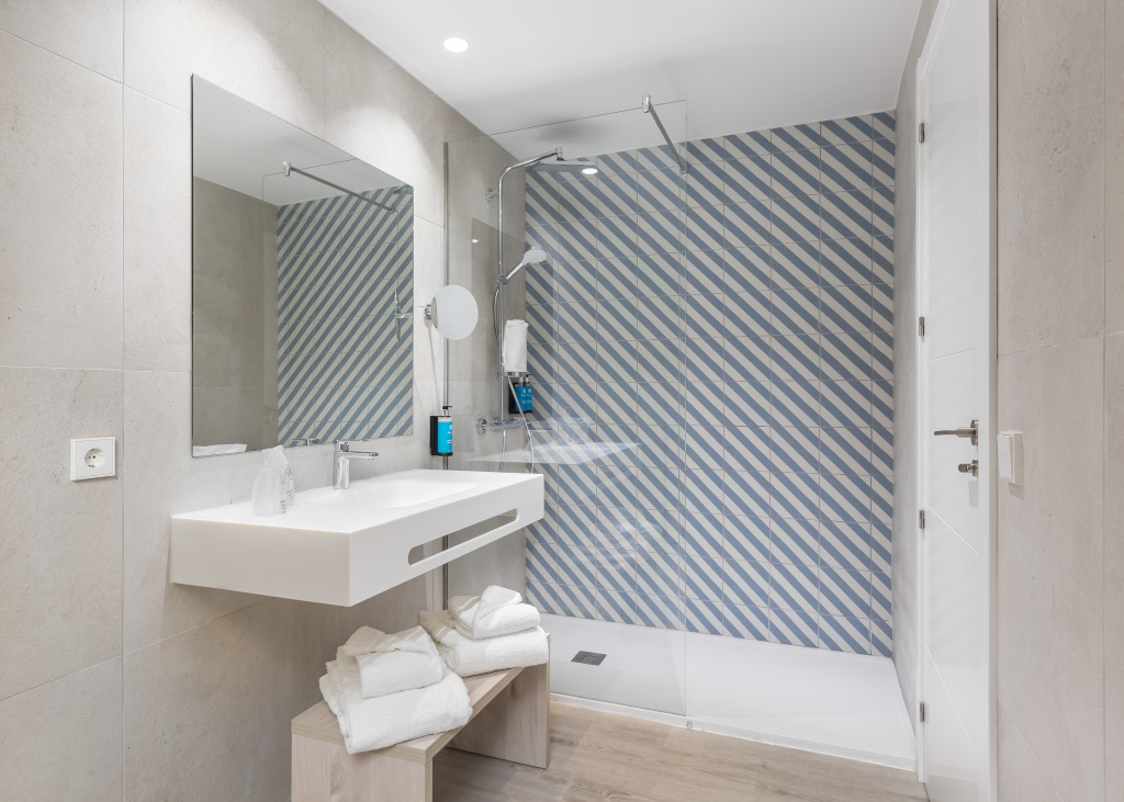 Moderne badkamer met blauw gestreepte tegels in een hotel op Tenerife.