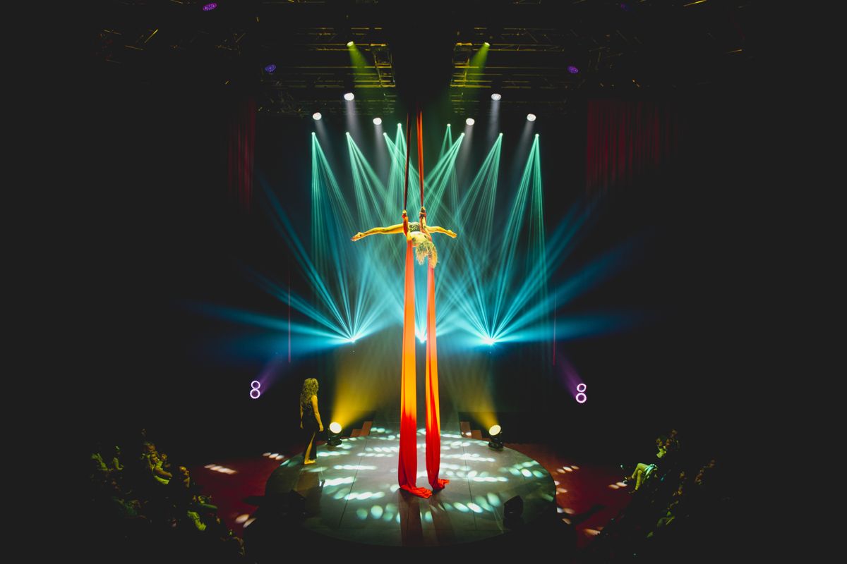 Acrobaat voert een luchtoptreden uit op een verlicht podium op Tenerife.