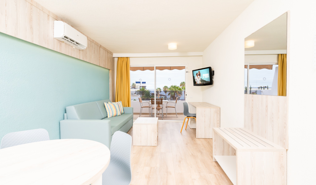 Moderne woonkamer met bank, tv en balkon in Santa Cruz de Tenerife.