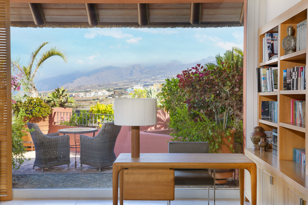 Interieur met tuin en berguitzicht vanaf terras op Tenerife, met tafel en stoelen.