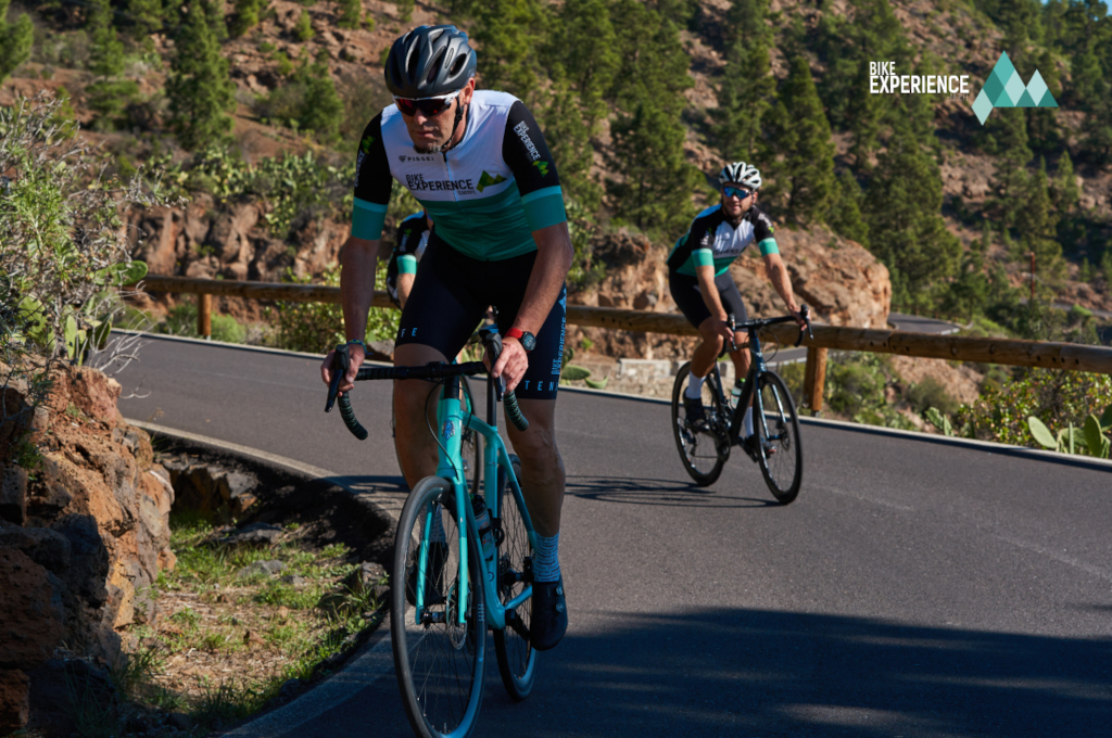 Fietsers op bergwegen op Tenerife, boslandschap op de achtergrond.