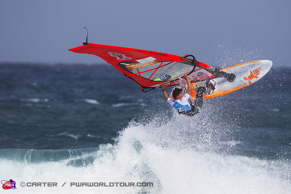Persoon die windsurft op een golf in El Médano, Tenerife.