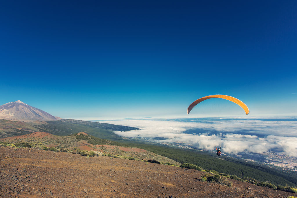 Paraglider vliegt nabij de berg Teide op Tenerife onder heldere lucht.