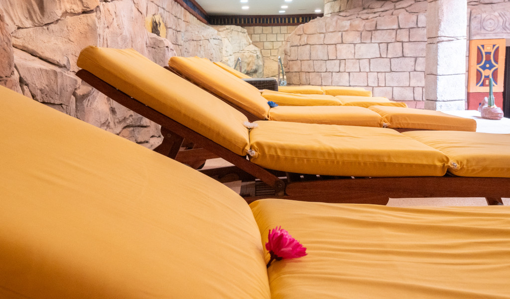 Gele ligstoelen naast een stenen muur in een spa in Costa Adeje, Tenerife.