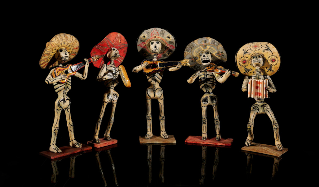 Mariachi van skeletten met instrumenten en hoeden.
