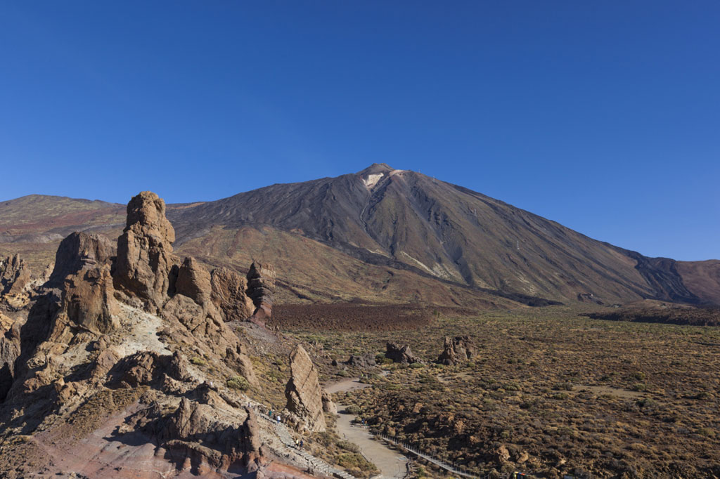 Rotsen en de berg Teide op Tenerife onder een blauwe lucht.