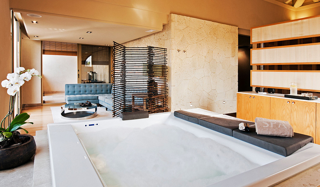 Jacuzzi in sparuimte met blauwe bank en witte orchidee op Tenerife.
